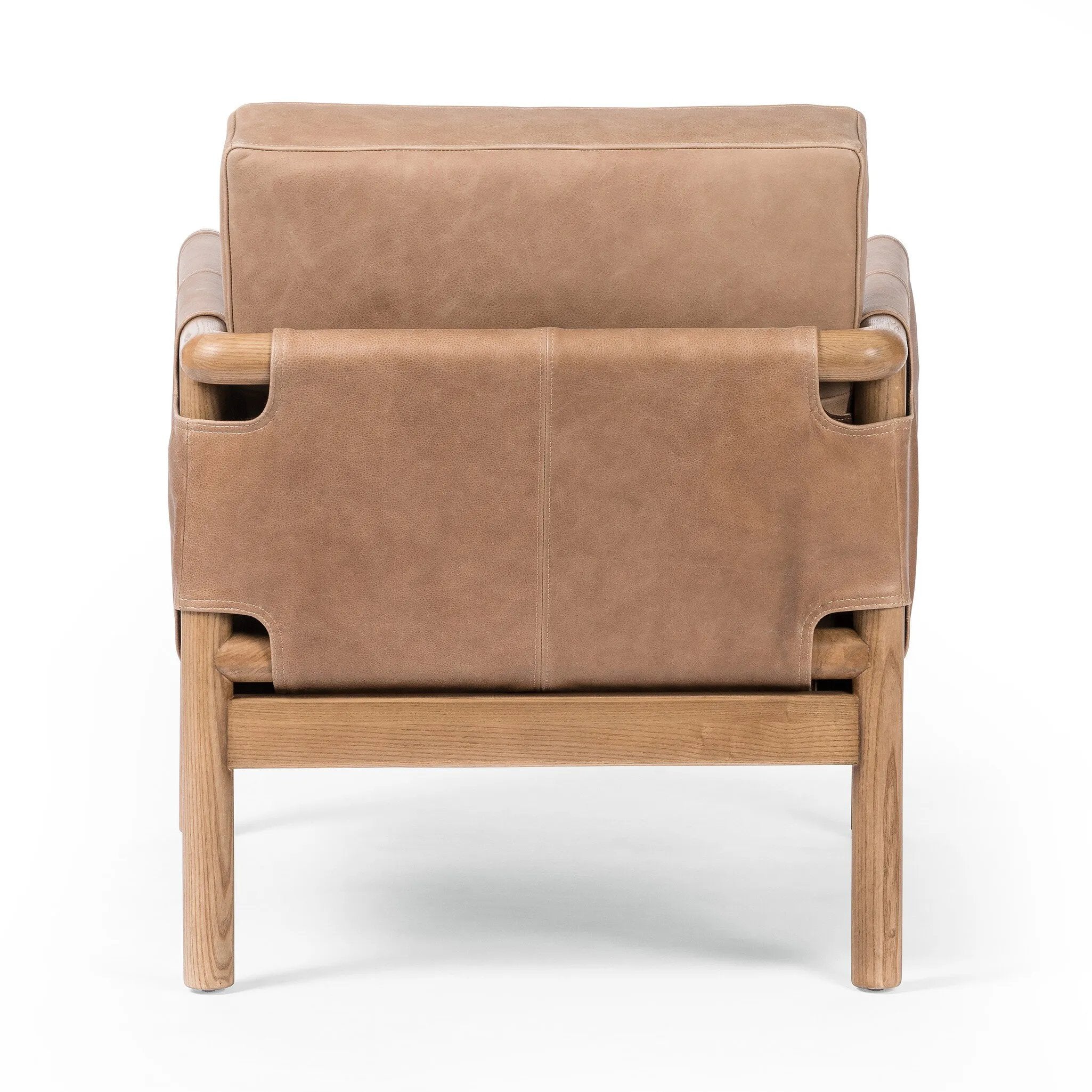 Safari inspiration meets zen aspirations. A cylindrical frame is crafted, smoothed and rounded from solid ash wood. Includes two loose feather-blend cushions covered in subtly distressed thick cut leather in a neutral taupe hue for a monochromatic look Amethyst Home provides interior design, new home construction design consulting, vintage area rugs, and lighting in the Dallas metro area.