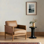 Safari inspiration meets zen aspirations. A cylindrical frame is crafted, smoothed and rounded from solid ash wood. Includes two loose feather-blend cushions covered in subtly distressed thick cut leather in a neutral taupe hue for a monochromatic look Amethyst Home provides interior design, new home construction design consulting, vintage area rugs, and lighting in the Nashville metro area.