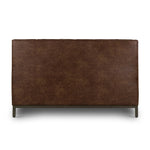Subtle, modern elegance. A low, tufted headboard in a vintage tobacco faux leather pairs with a simple gunmetal iron base Amethyst Home provides interior design, new home construction design consulting, vintage area rugs, and lighting in the Alpharetta metro area.