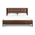 Subtle, modern elegance. A low, tufted headboard in a vintage tobacco faux leather pairs with a simple gunmetal iron base Amethyst Home provides interior design, new home construction design consulting, vintage area rugs, and lighting in the Houston metro area.