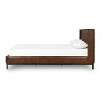 Subtle, modern elegance. A low, tufted headboard in a vintage tobacco faux leather pairs with a simple gunmetal iron base Amethyst Home provides interior design, new home construction design consulting, vintage area rugs, and lighting in the Monterey metro area.