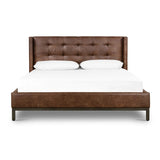 Subtle, modern elegance. A low, tufted headboard in a vintage tobacco faux leather pairs with a simple gunmetal iron base Amethyst Home provides interior design, new home construction design consulting, vintage area rugs, and lighting in the Park City metro area.