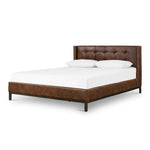Subtle, modern elegance. A low, tufted headboard in a vintage tobacco faux leather pairs with a simple gunmetal iron base Amethyst Home provides interior design, new home construction design consulting, vintage area rugs, and lighting in the Salt Lake City metro area.