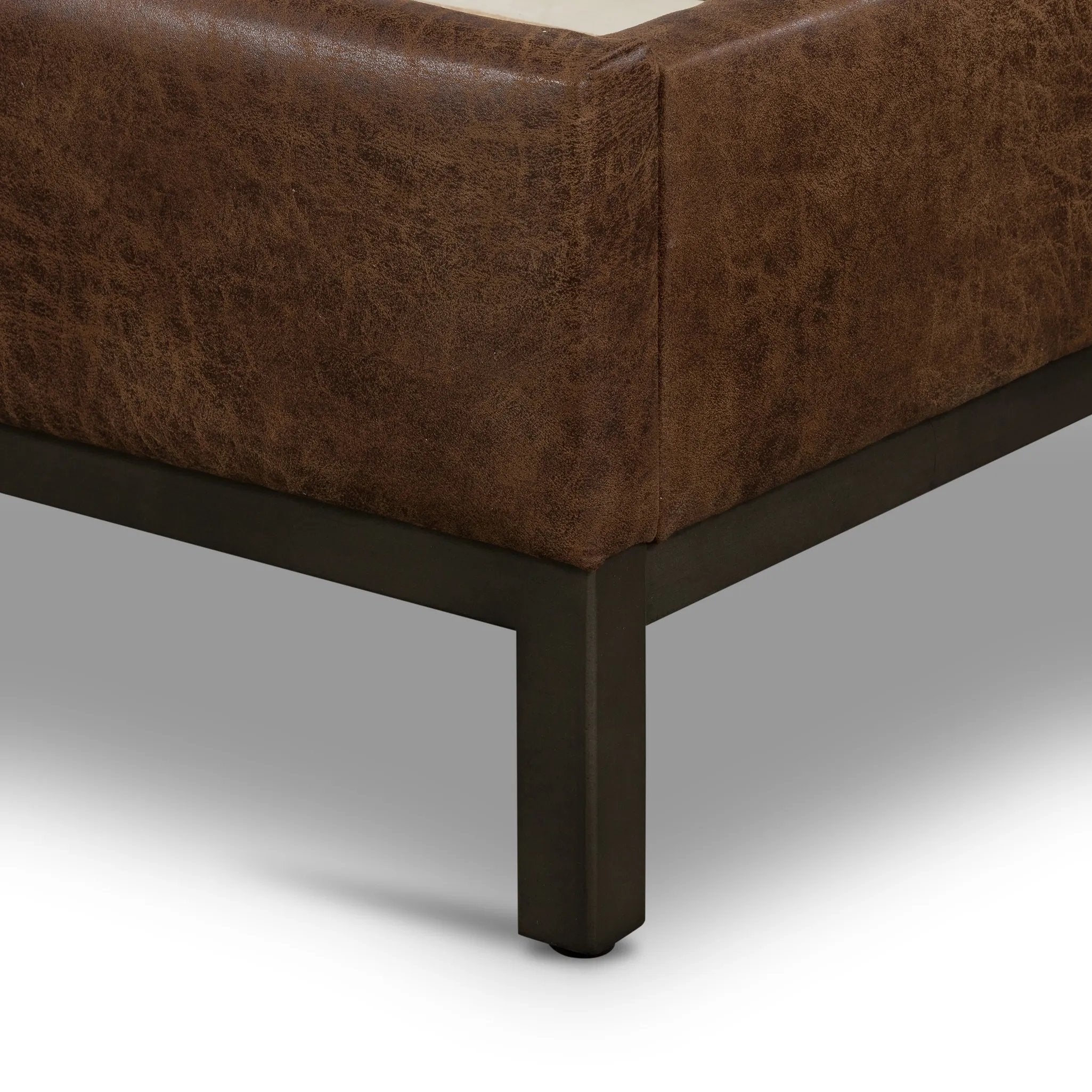 Subtle, modern elegance. A low, tufted headboard in a vintage tobacco faux leather pairs with a simple gunmetal iron base Amethyst Home provides interior design, new home construction design consulting, vintage area rugs, and lighting in the Seattle metro area.