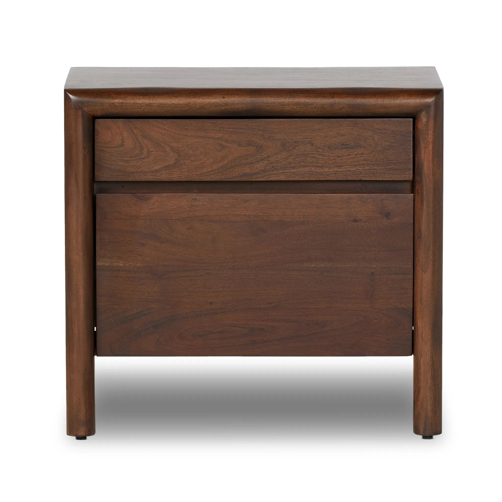A faux live edge lends natural character to the waterfall frame, its mitered corners enhancing the seamless silhouette. Soft volumes and thick proportions exude a sense of permanence, while chamfered drawer pulls add refined functionality. The warm wood tones celebrate acacia's rich grain patterns Amethyst Home provides interior design, new home construction design consulting, vintage area rugs, and lighting in the Alpharetta metro area.