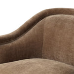 With elements of past eras at play, this updated Deco chair features a rounded back, sloped arms and a dramatic channel. The 