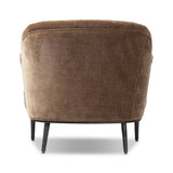 With elements of past eras at play, this updated Deco chair features a rounded back, sloped arms and a dramatic channel. The 