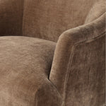 With elements of past eras at play, this updated Deco chair features a rounded back, sloped arms and a dramatic channel. The 