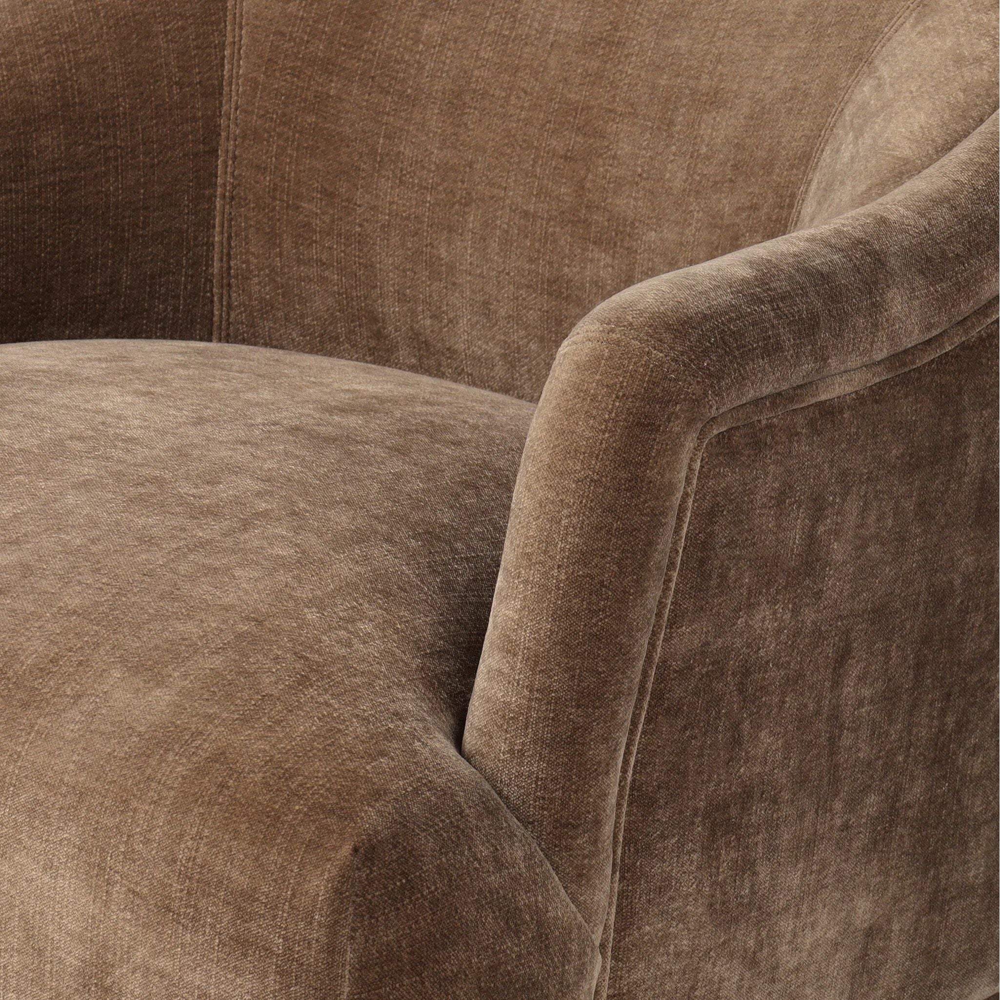 With elements of past eras at play, this updated Deco chair features a rounded back, sloped arms and a dramatic channel. The 