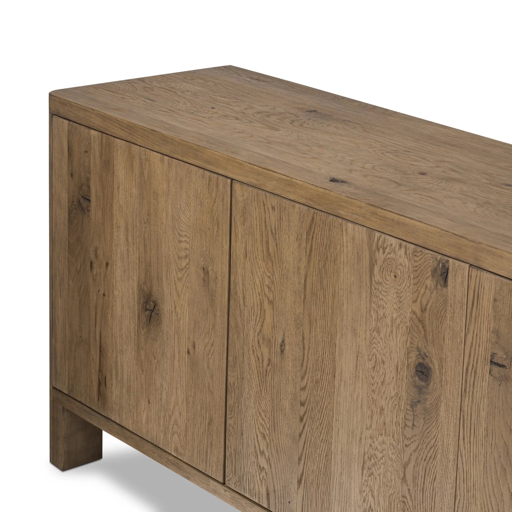 Made from resawn oak with a worn, natural finish, a long, streamlined sideboard offers ample storage space behind four push-latch doors. Subtly rounded corners add softness to otherwise clean lines, while knots and graining offer a naturally rich look. Dual rear cutouts for seamless cord management Amethyst Home provides interior design, new home construction design consulting, vintage area rugs, and lighting in the Calabasas metro area.