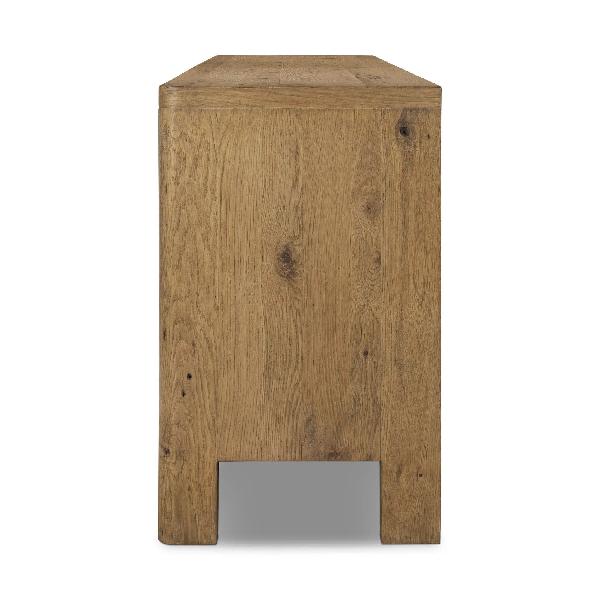 Made from resawn oak with a worn, natural finish, a long, streamlined sideboard offers ample storage space behind four push-latch doors. Subtly rounded corners add softness to otherwise clean lines, while knots and graining offer a naturally rich look. Dual rear cutouts for seamless cord management Amethyst Home provides interior design, new home construction design consulting, vintage area rugs, and lighting in the Houston metro area.