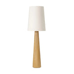 Modern minimal meets traditional. A tapered wood floor lamp base is topped with a design-forward boucle linen shade Amethyst Home provides interior design, new home construction design consulting, vintage area rugs, and lighting in the Austin metro area.