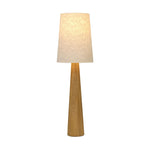 Modern minimal meets traditional. A tapered wood floor lamp base is topped with a design-forward boucle linen shade Amethyst Home provides interior design, new home construction design consulting, vintage area rugs, and lighting in the Houston metro area.