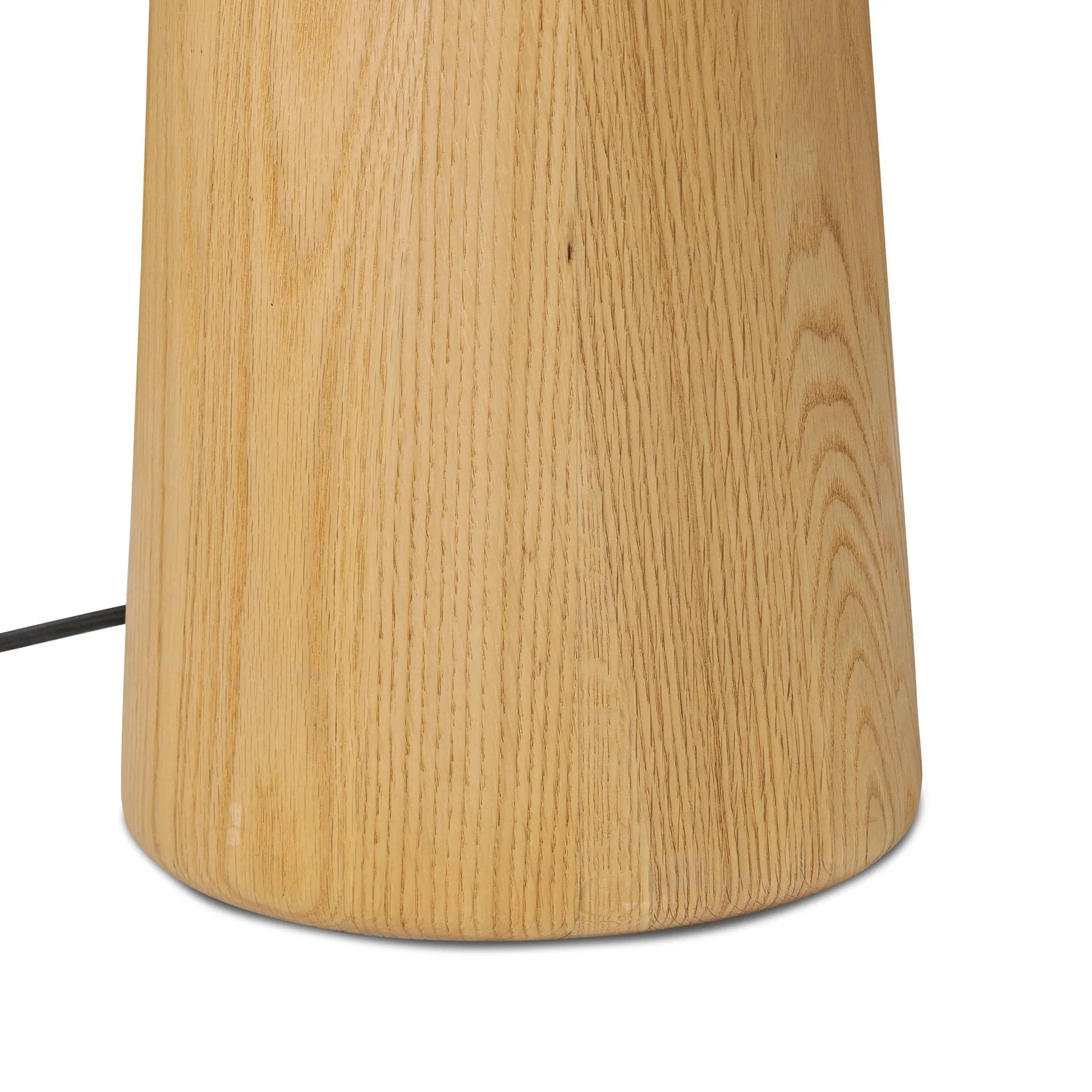 Modern minimal meets traditional. A tapered wood floor lamp base is topped with a design-forward boucle linen shade Amethyst Home provides interior design, new home construction design consulting, vintage area rugs, and lighting in the Tampa metro area.