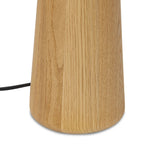 Modern minimal meets traditional. A tapered wood table lamp base is topped with a design-forward boucle linen shade Amethyst Home provides interior design, new home construction design consulting, vintage area rugs, and lighting in the Charlotte metro area.