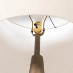 A striking silhouette. An antique brass finish highlights iron's gradual blending of hues for a distinctive ombre effect on this tapered metal base. Topped with a 100% cotton shade Amethyst Home provides interior design, new home construction design consulting, vintage area rugs, and lighting in the Scottsdale metro area.