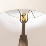 A striking silhouette. An antique brass finish highlights iron's gradual blending of hues for a distinctive ombre effect on this tapered metal base. Topped with a 100% cotton shade Amethyst Home provides interior design, new home construction design consulting, vintage area rugs, and lighting in the Scottsdale metro area.