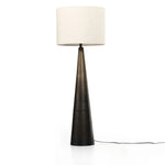 A striking silhouette. An antique brass finish highlights iron's gradual blending of hues for a distinctive ombre effect on this tapered metal base. Topped with a 100% cotton shade Amethyst Home provides interior design, new home construction design consulting, vintage area rugs, and lighting in the Seattle metro area.