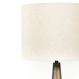 A striking silhouette. An antique brass finish highlights iron's gradual blending of hues for a distinctive ombre effect on this tapered metal base. Topped with a 100% cotton shade Amethyst Home provides interior design, new home construction design consulting, vintage area rugs, and lighting in the Tampa metro area.