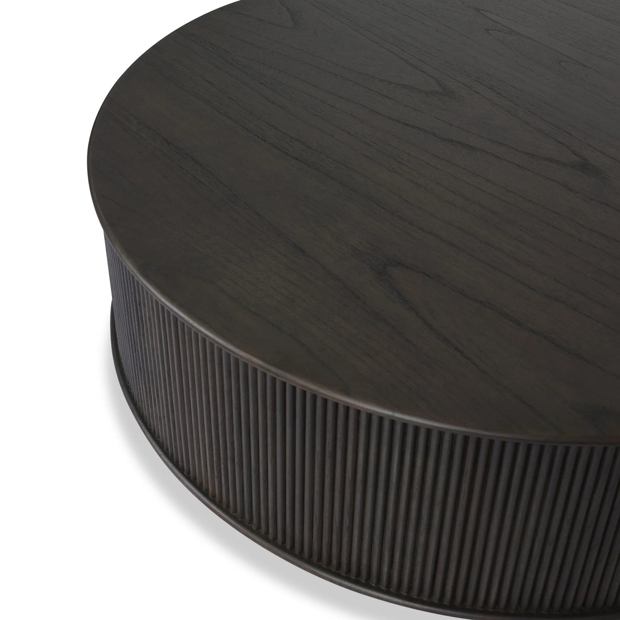 An artisanal take on texture. Made from black-finished mindi with a plinth-style base, a reeding pattern is carved around the entirety of this coffee table table for a fresh, approachable look.As fans of clean style at Amethyst, we love the nature inspired Ona Coffee Table - Smoked Black Mindi - Smoked Black Mindi Veneer. Amethyst Home provides interior design, new home construction design consulting, vintage area rugs, and lighting in the Alpharetta metro area.