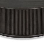 An artisanal take on texture. Made from black-finished mindi with a plinth-style base, a reeding pattern is carved around the entirety of this coffee table table for a fresh, approachable look.As fans of clean style at Amethyst, we love the nature inspired Ona Coffee Table - Smoked Black Mindi - Smoked Black Mindi Veneer. Amethyst Home provides interior design, new home construction design consulting, vintage area rugs, and lighting in the Charlotte metro area.