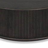 An artisanal take on texture. Made from black-finished mindi with a plinth-style base, a reeding pattern is carved around the entirety of this coffee table table for a fresh, approachable look.As fans of clean style at Amethyst, we love the nature inspired Ona Coffee Table - Smoked Black Mindi - Smoked Black Mindi Veneer. Amethyst Home provides interior design, new home construction design consulting, vintage area rugs, and lighting in the Charlotte metro area.