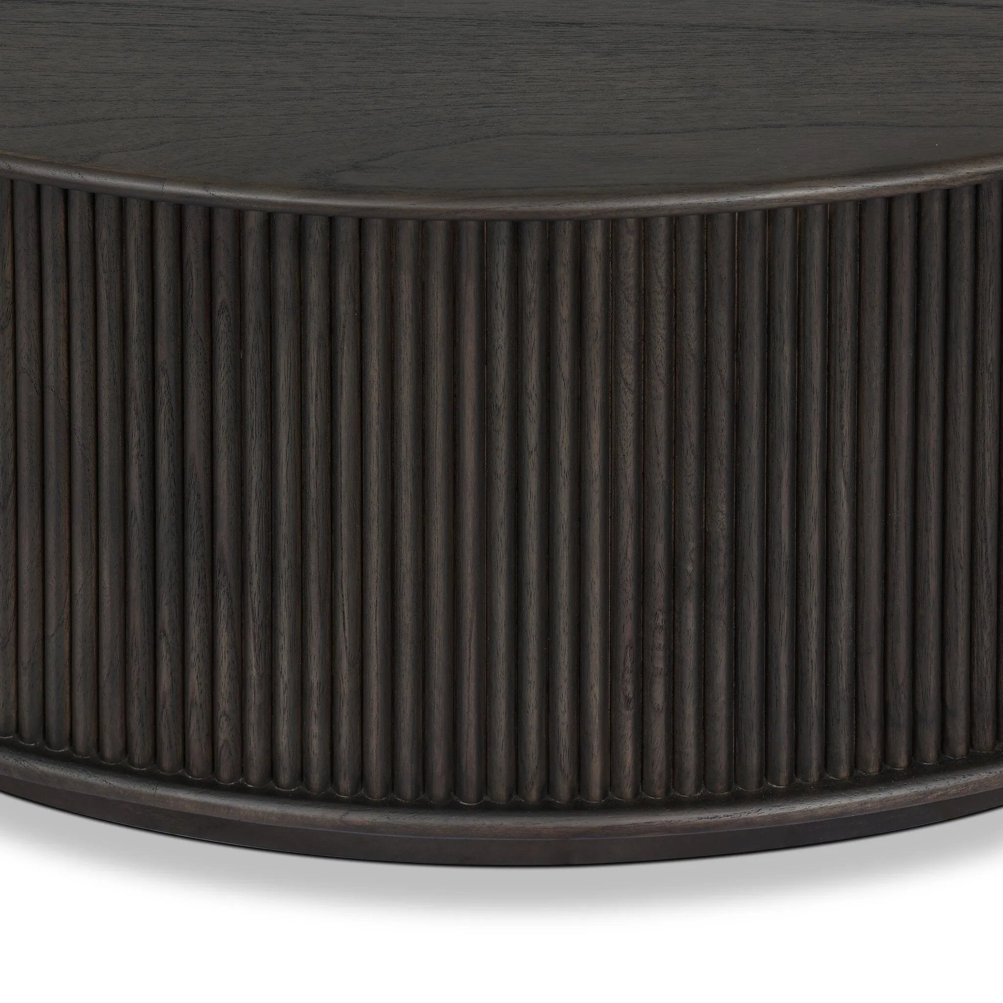 An artisanal take on texture. Made from black-finished mindi with a plinth-style base, a reeding pattern is carved around the entirety of this coffee table table for a fresh, approachable look.As fans of clean style at Amethyst, we love the nature inspired Ona Coffee Table - Smoked Black Mindi - Smoked Black Mindi Veneer. Amethyst Home provides interior design, new home construction design consulting, vintage area rugs, and lighting in the Charlotte metro area.