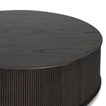 An artisanal take on texture. Made from black-finished mindi with a plinth-style base, a reeding pattern is carved around the entirety of this coffee table table for a fresh, approachable look.As fans of clean style at Amethyst, we love the nature inspired Ona Coffee Table - Smoked Black Mindi - Smoked Black Mindi Veneer. Amethyst Home provides interior design, new home construction design consulting, vintage area rugs, and lighting in the Newport Beach metro area.