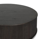An artisanal take on texture. Made from black-finished mindi with a plinth-style base, a reeding pattern is carved around the entirety of this coffee table table for a fresh, approachable look.As fans of clean style at Amethyst, we love the nature inspired Ona Coffee Table - Smoked Black Mindi - Smoked Black Mindi Veneer. Amethyst Home provides interior design, new home construction design consulting, vintage area rugs, and lighting in the Newport Beach metro area.