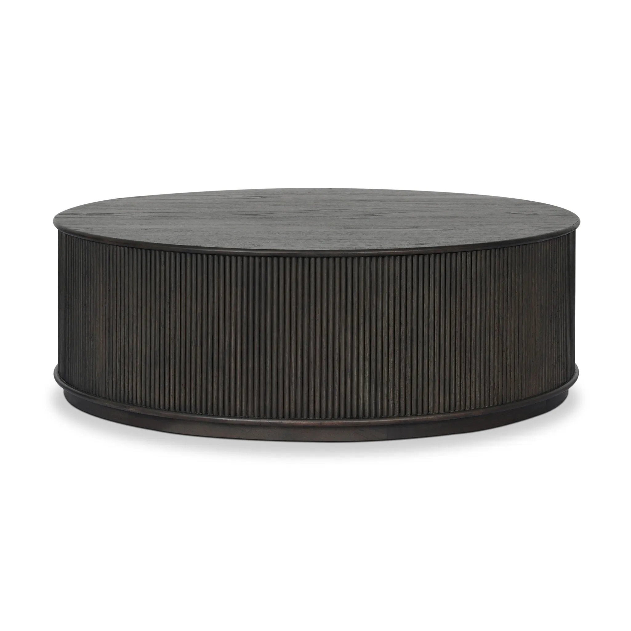 An artisanal take on texture. Made from black-finished mindi with a plinth-style base, a reeding pattern is carved around the entirety of this coffee table table for a fresh, approachable look.As fans of clean style at Amethyst, we love the nature inspired Ona Coffee Table - Smoked Black Mindi - Smoked Black Mindi Veneer. Amethyst Home provides interior design, new home construction design consulting, vintage area rugs, and lighting in the Salt Lake City metro area.