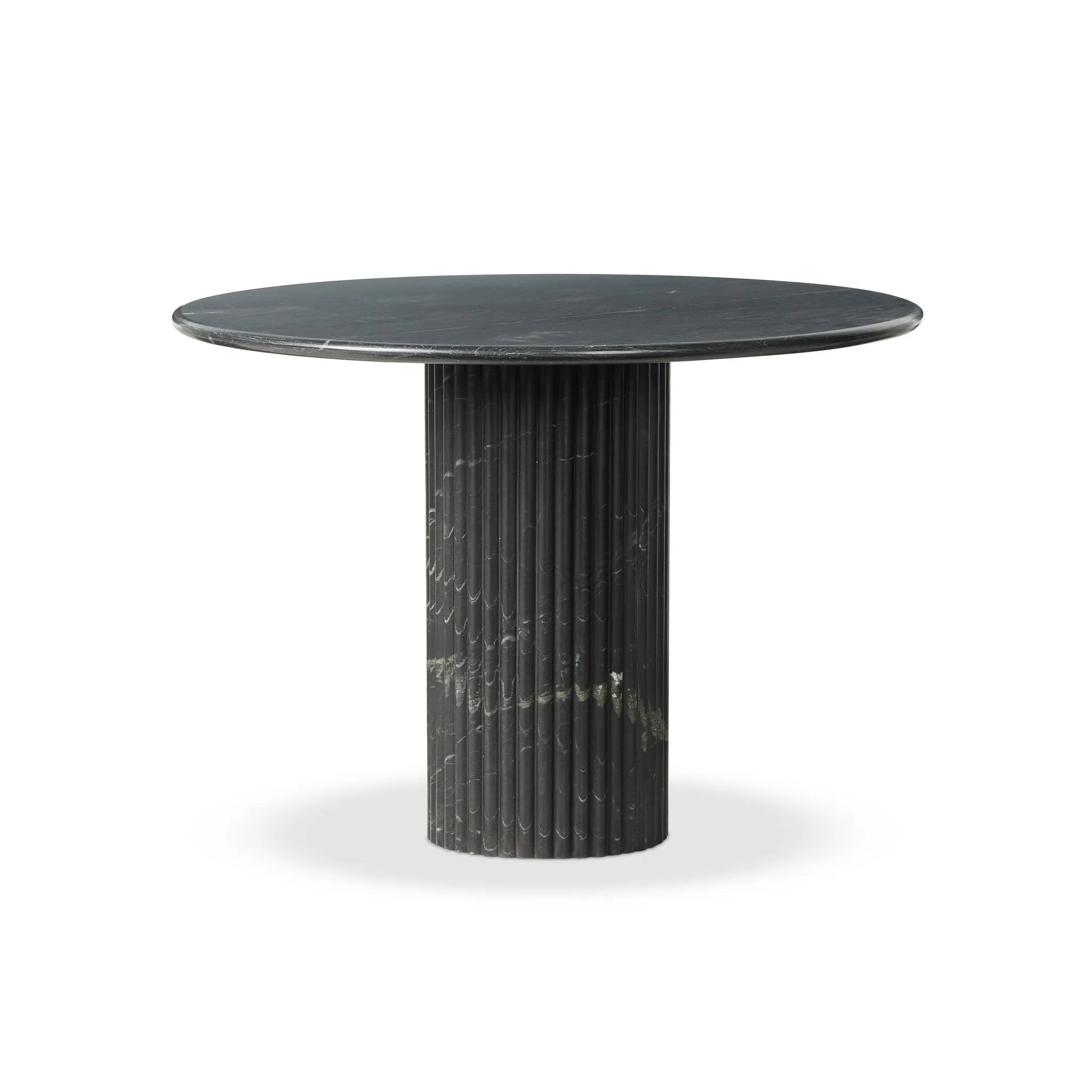 Inspired by Italian design, a swirling marble base is scalloped for a linear look with heavy texture, finished with a rounded, bistro-size tabletop of polished black marble Amethyst Home provides interior design, new home construction design consulting, vintage area rugs, and lighting in the Portland metro area.