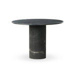 Inspired by Italian design, a swirling marble base is scalloped for a linear look with heavy texture, finished with a rounded, bistro-size tabletop of polished black marble Amethyst Home provides interior design, new home construction design consulting, vintage area rugs, and lighting in the Scottsdale metro area.