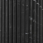 Inspired by Italian design, a swirling marble base is scalloped for a linear look with heavy texture, finished with a rounded, bistro-size tabletop of polished black marble Amethyst Home provides interior design, new home construction design consulting, vintage area rugs, and lighting in the Seattle metro area.