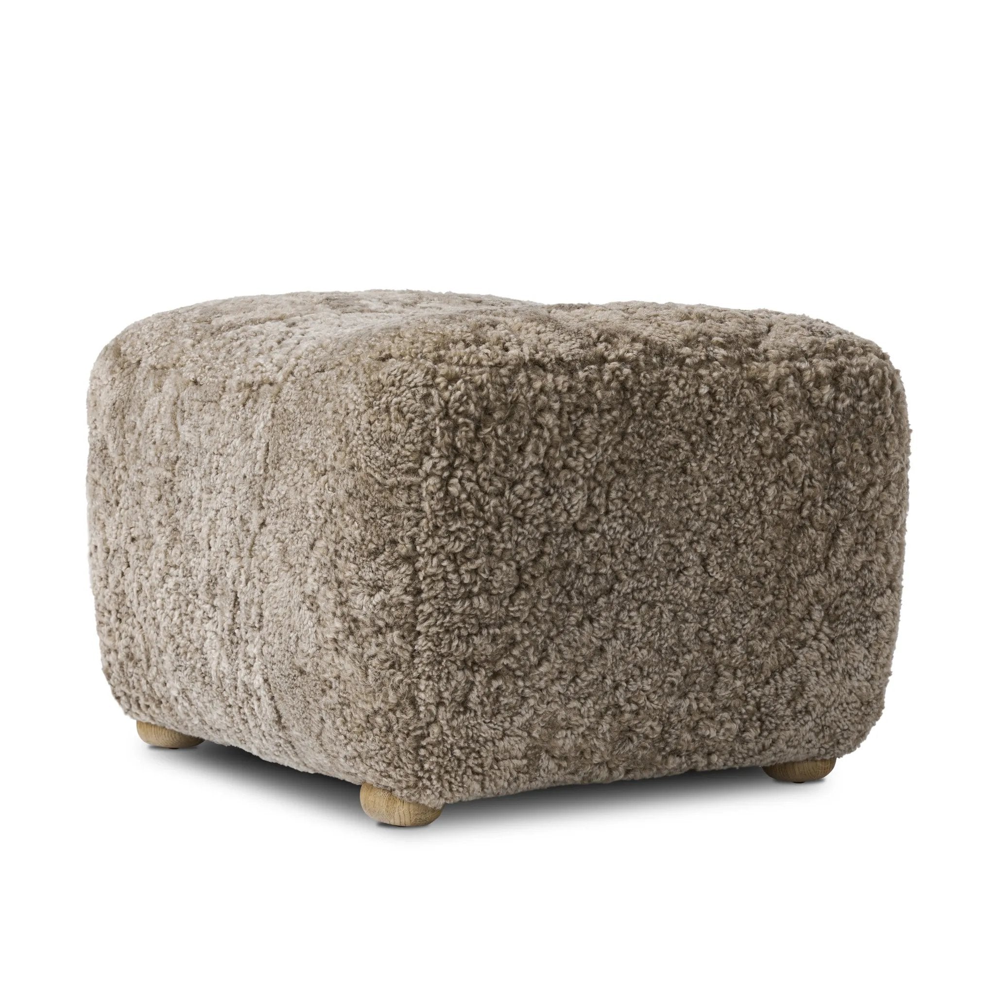 A subtle sweetheart shape paired with beige shearling plays into this ottoman's found object appeal. S-spring suspension offers a comfy place to sit and the shearling upholstery brings depth and vintage vibes throughout. Perfect styled alone or as part of a set for added drama. A design collaboration by Amber Lewis and Four Hands. Amethyst Home provides interior design, new home construction design consulting, vintage area rugs, and lighting in the Des Moines metro area.