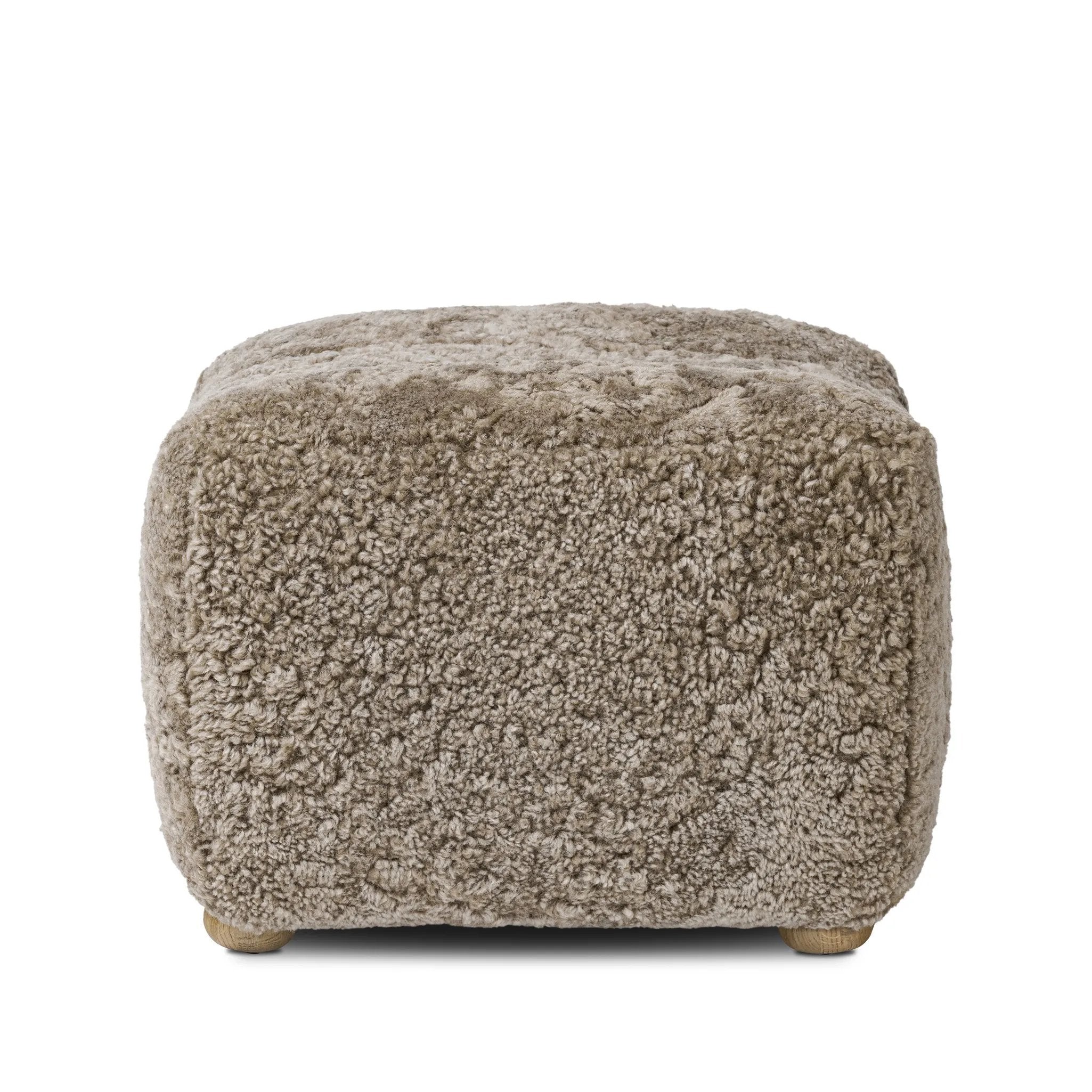 A subtle sweetheart shape paired with beige shearling plays into this ottoman's found object appeal. S-spring suspension offers a comfy place to sit and the shearling upholstery brings depth and vintage vibes throughout. Perfect styled alone or as part of a set for added drama. A design collaboration by Amber Lewis and Four Hands. Amethyst Home provides interior design, new home construction design consulting, vintage area rugs, and lighting in the Los Angeles metro area.