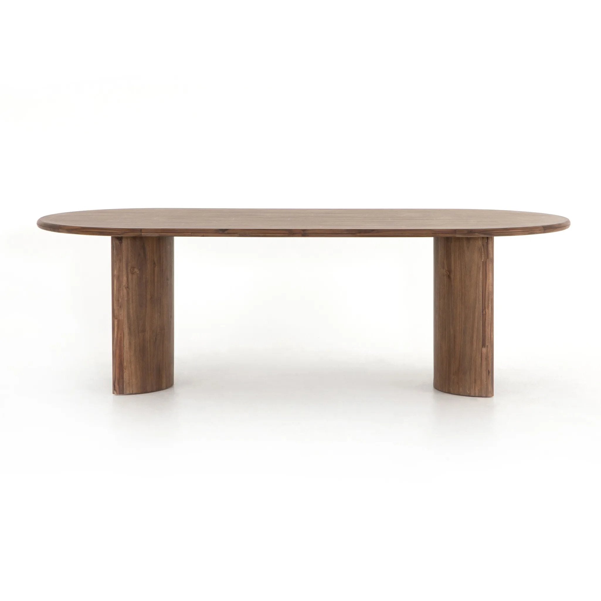 A study in shape. Solid brown acacia forms crescent-shaped legs and sprawling oval tabletop, bringing organic presence to the dining room Amethyst Home provides interior design, new home construction design consulting, vintage area rugs, and lighting in the Boston metro area.