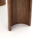 A study in shape. Solid brown acacia forms crescent-shaped legs and sprawling oval tabletop, bringing organic presence to the dining room Amethyst Home provides interior design, new home construction design consulting, vintage area rugs, and lighting in the Miami metro area.