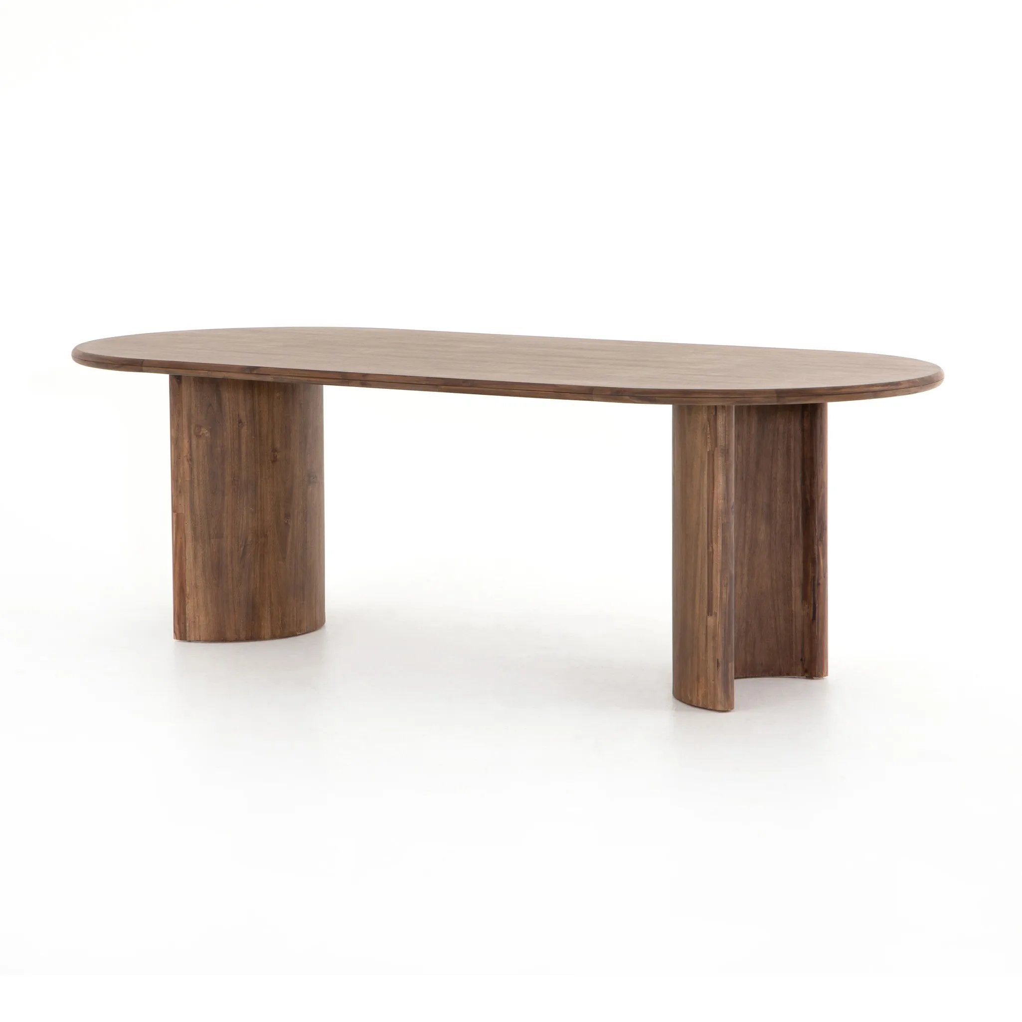 A study in shape. Solid brown acacia forms crescent-shaped legs and sprawling oval tabletop, bringing organic presence to the dining room Amethyst Home provides interior design, new home construction design consulting, vintage area rugs, and lighting in the Scottsdale metro area.
