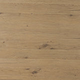 A study in shape. Solid brown oak forms crescent-shaped legs and sprawling oval tabletop, bringing organic presence to the dining room Amethyst Home provides interior design, new home construction design consulting, vintage area rugs, and lighting in the Park City metro area.