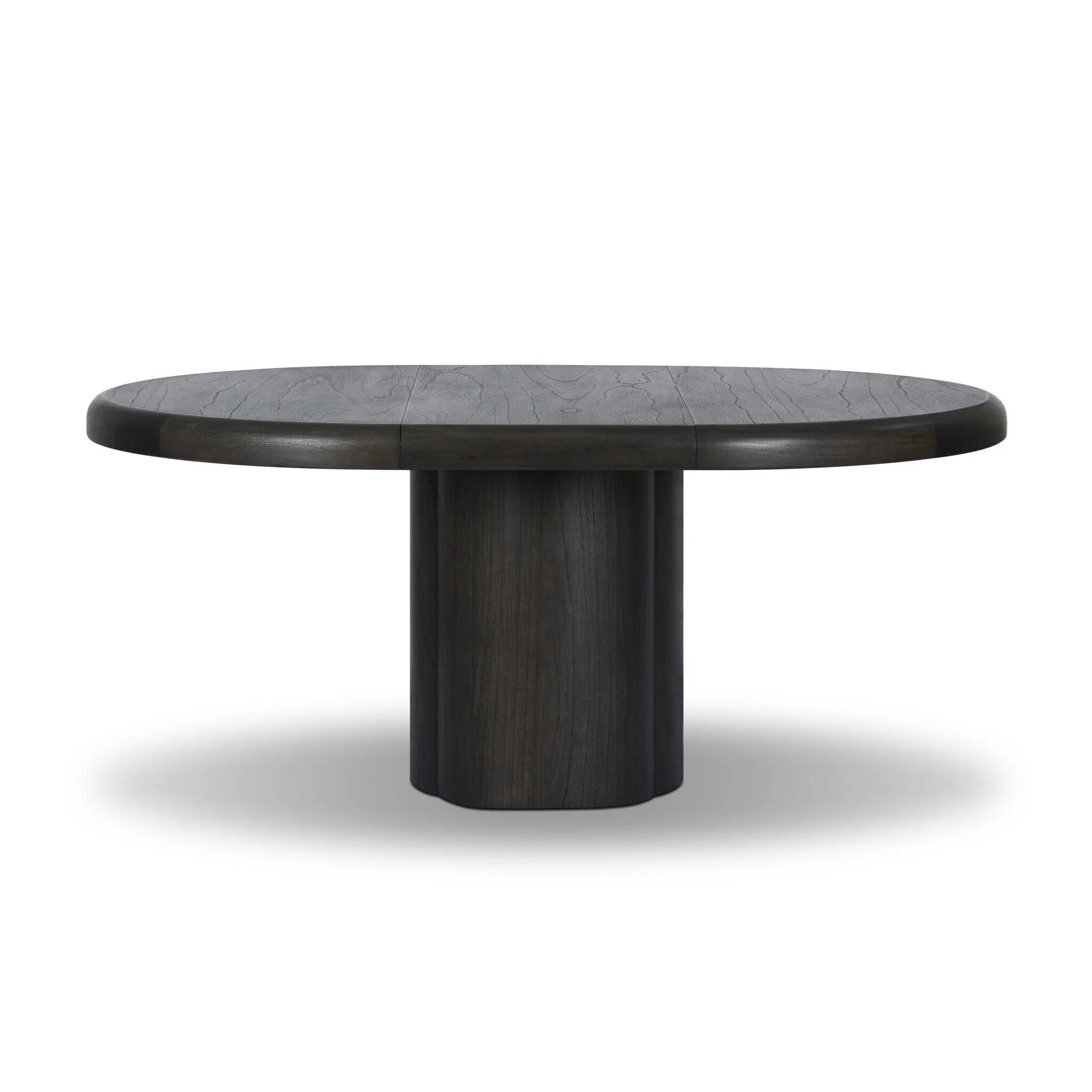 Make space for more guests with a rounded extension table of smoked black mindi, with beautiful visible graining. Inside the tabletop, a hidden mechanism allows for expansion from 48" to 68".As fans of organic modern design at Amethyst, we love the designer inspired Pemble Extension Dining Table - Smoked Black Mindi Veneer. Amethyst Home provides interior design, new home construction design consulting, vintage area rugs, and lighting in the Monterey metro area.