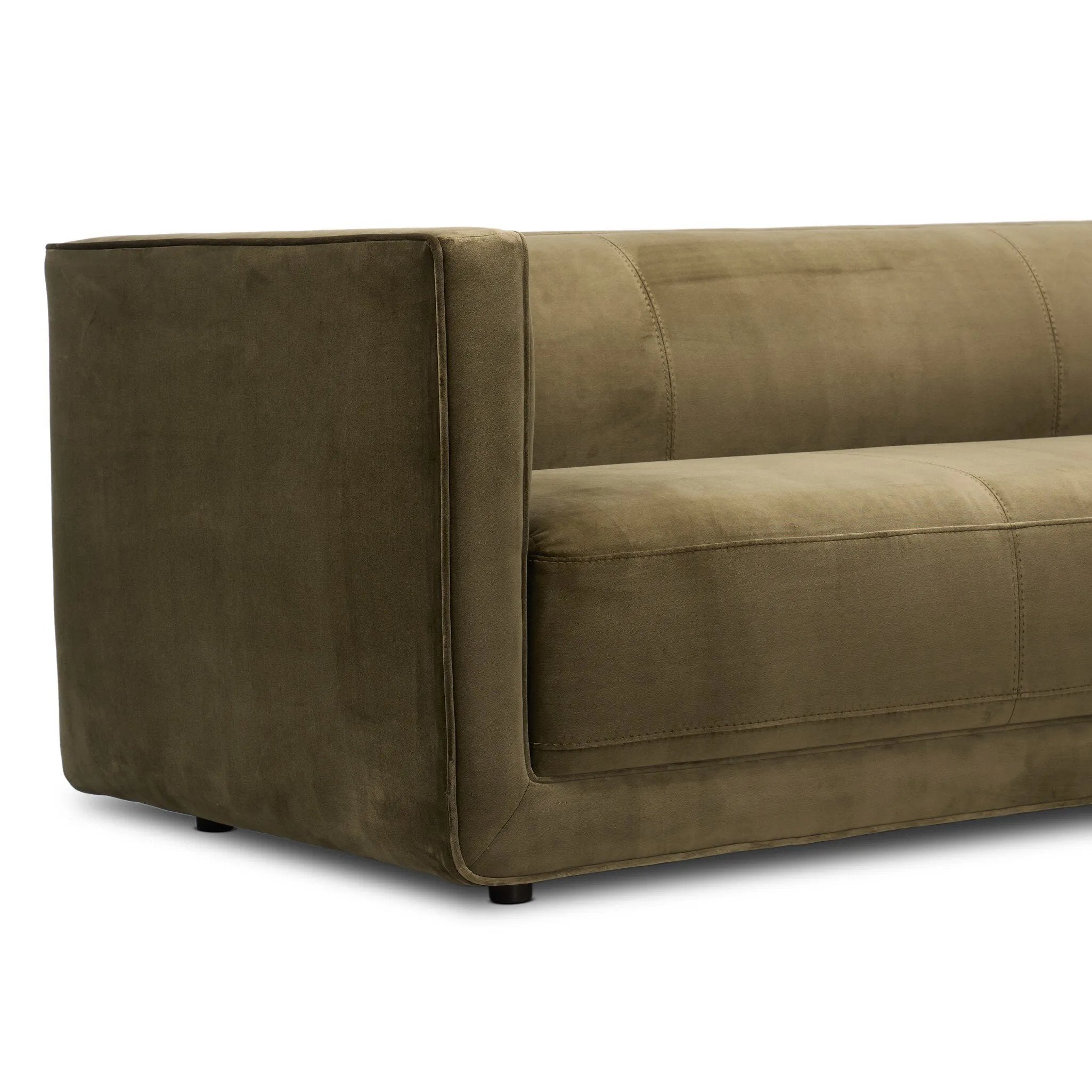 A clean, angular sectional in an eye-catching color. Upholstered in an olive cotton blend, with blind stitching along the seat and back cushions. The slight pronounced seat cushion creates an illusion of being loose, but is actually a fixed cushion with expert tailoring. A piping channel detail gives the arm a finished look Amethyst Home provides interior design, new home construction design consulting, vintage area rugs, and lighting in the Des Moines metro area.