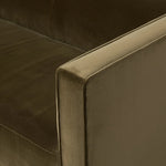 A clean, angular sectional in an eye-catching color. Upholstered in an olive cotton blend, with blind stitching along the seat and back cushions. The slight pronounced seat cushion creates an illusion of being loose, but is actually a fixed cushion with expert tailoring. A piping channel detail gives the arm a finished look Amethyst Home provides interior design, new home construction design consulting, vintage area rugs, and lighting in the Houston metro area.