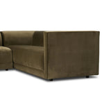 A clean, angular sectional in an eye-catching color. Upholstered in an olive cotton blend, with blind stitching along the seat and back cushions. The slight pronounced seat cushion creates an illusion of being loose, but is actually a fixed cushion with expert tailoring. A piping channel detail gives the arm a finished look Amethyst Home provides interior design, new home construction design consulting, vintage area rugs, and lighting in the Los Angeles metro area.