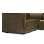 A clean, angular sectional in an eye-catching color. Upholstered in an olive cotton blend, with blind stitching along the seat and back cushions. The slight pronounced seat cushion creates an illusion of being loose, but is actually a fixed cushion with expert tailoring. A piping channel detail gives the arm a finished look Amethyst Home provides interior design, new home construction design consulting, vintage area rugs, and lighting in the San Diego metro area.