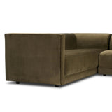 A clean, angular sectional in an eye-catching color. Upholstered in an olive cotton blend, with blind stitching along the seat and back cushions. The slight pronounced seat cushion creates an illusion of being loose, but is actually a fixed cushion with expert tailoring. A piping channel detail gives the arm a finished look Amethyst Home provides interior design, new home construction design consulting, vintage area rugs, and lighting in the San Diego metro area.