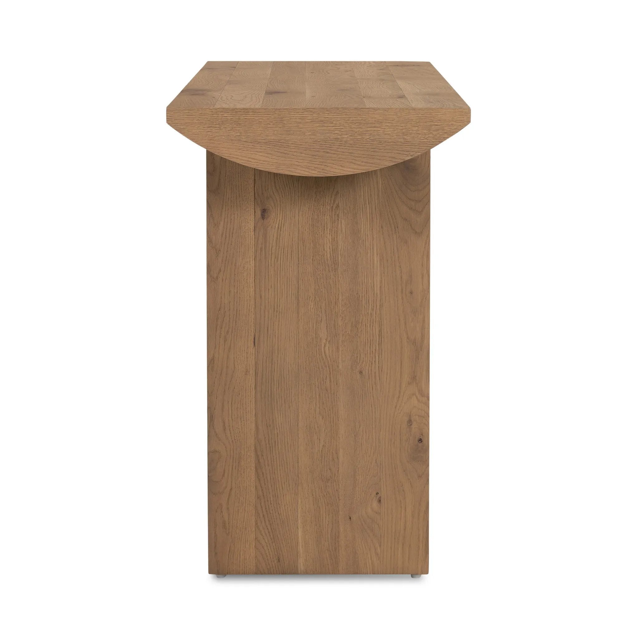 A shape-driven console table made from thick-cut oak veneer features overscale proportions and half-moon shaping, with a warm grey-brown finish Amethyst Home provides interior design, new home construction design consulting, vintage area rugs, and lighting in the Charlotte metro area.
