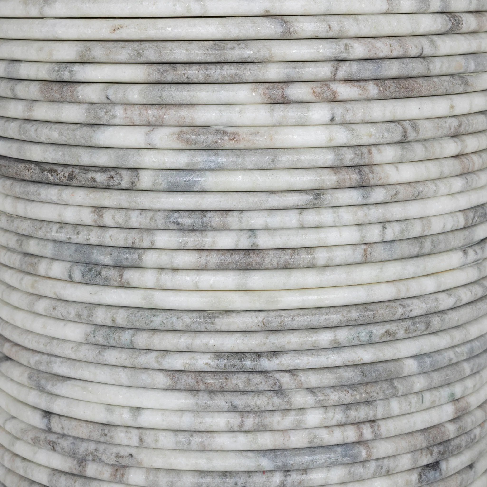 A bold, sculptural presence with movement throughout. This solid marble table features a stacked fluted base and bullnose-edged top that combine to let the natural variation of the material take center stage.As fans of clean design at Amethyst, we love the nature inspired Reeves Dining Table - River Grey Marble. Amethyst Home provides interior design, new home construction design consulting, vintage area rugs, and lighting in the Austin metro area.