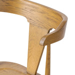 A fresh, bar-style take on mid-century Windsor seating, featuring a bowed, sculptural silhouette and soft black finish to highlight the natural grain of weathered oak Amethyst Home provides interior design, new home construction design consulting, vintage area rugs, and lighting in the Kansas City metro area.