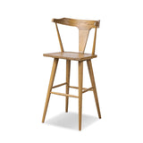 A fresh, bar-style take on mid-century Windsor seating, featuring a bowed, sculptural silhouette and soft black finish to highlight the natural grain of weathered oak Amethyst Home provides interior design, new home construction design consulting, vintage area rugs, and lighting in the Omaha metro area.