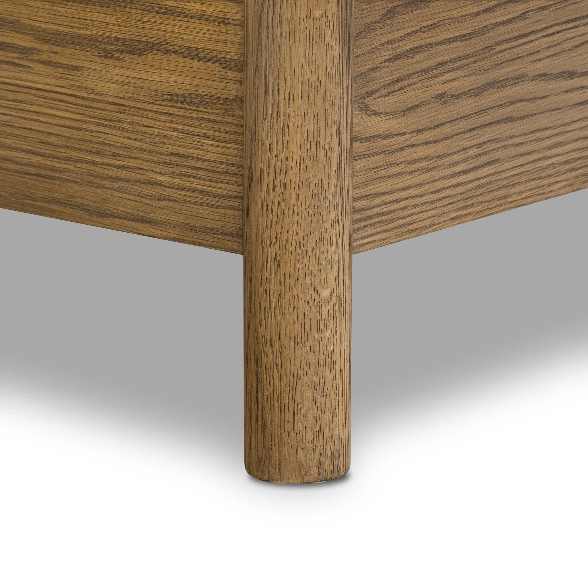 Rounded, chunky dowel legs in an amber oak finish frame the tan top-grain leather headboard of this simple-but-striking bed frame Amethyst Home provides interior design, new home construction design consulting, vintage area rugs, and lighting in the Miami metro area.